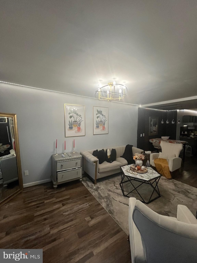 living room featuring a notable chandelier, vaulted ceiling, and dark hardwood / wood-style flooring