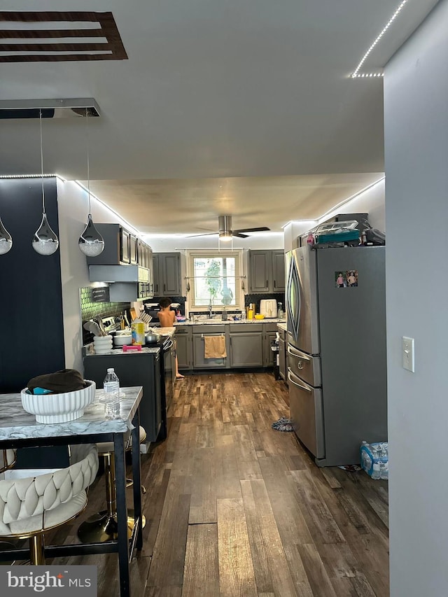 kitchen with pendant lighting, stainless steel fridge, dark wood-type flooring, range with electric cooktop, and gray cabinets