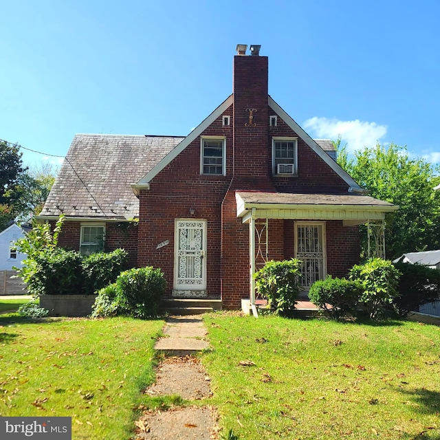 view of front of property with cooling unit and a front lawn