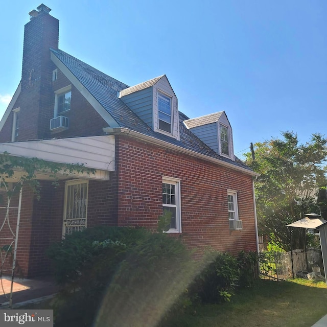 view of side of home featuring a lawn