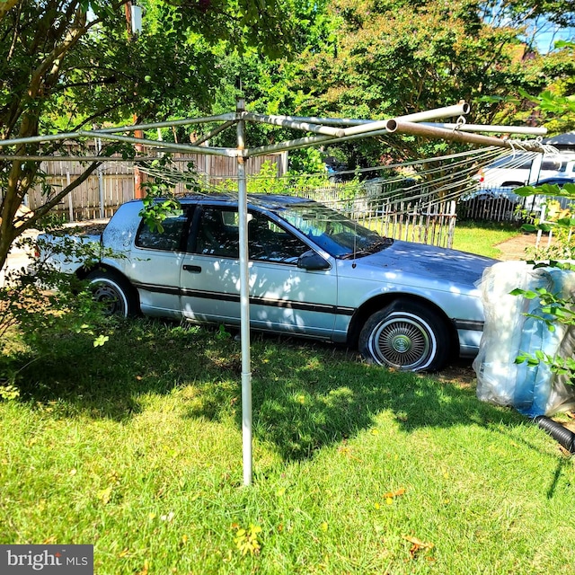 view of parking / parking lot featuring a yard