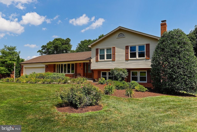 tri-level home featuring a front yard and a garage