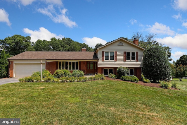 split level home with a front lawn and a garage