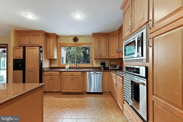 kitchen with built in appliances, sink, and light tile patterned floors