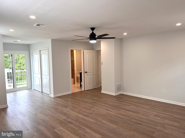 unfurnished room with dark wood-style floors, recessed lighting, visible vents, and baseboards