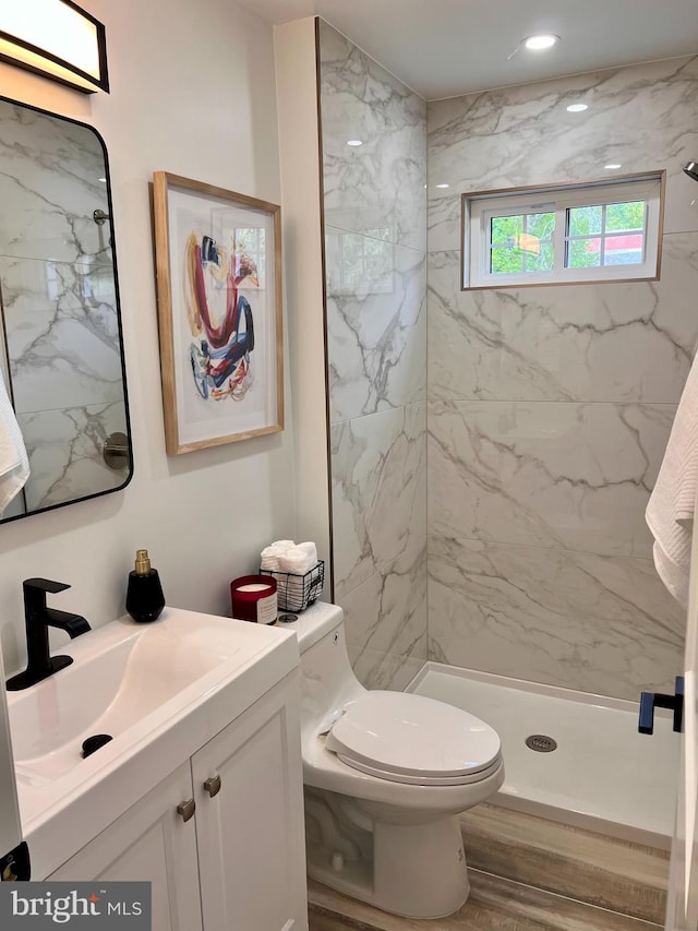 full bathroom featuring a shower stall, toilet, and vanity