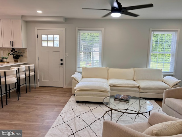 living room with light wood-style floors, recessed lighting, plenty of natural light, and ceiling fan