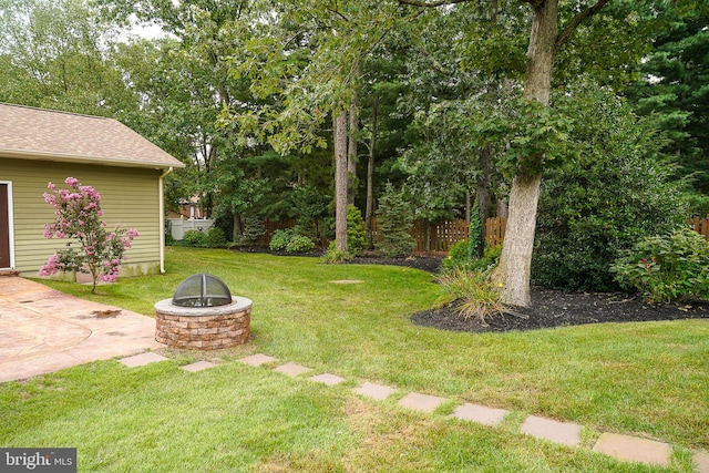 view of yard with a patio and an outdoor fire pit