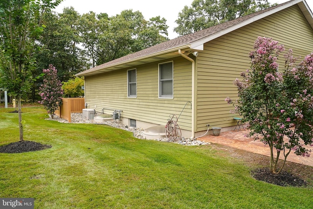 view of side of property with a lawn