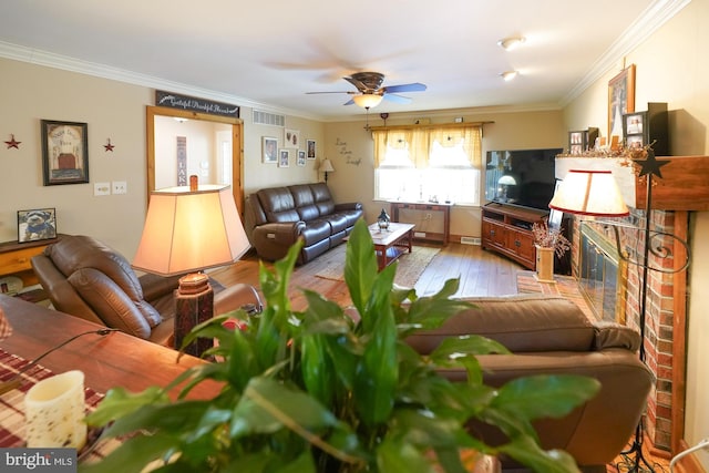 living room featuring ceiling fan, light hardwood / wood-style flooring, and ornamental molding