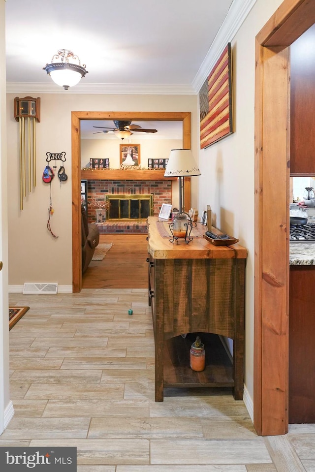 hallway featuring crown molding and light hardwood / wood-style floors