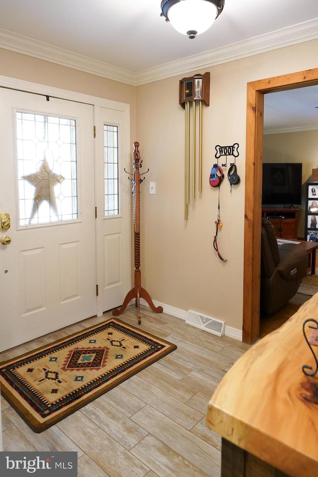 entrance foyer with wood-type flooring and crown molding