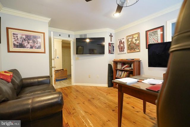 home office with ornamental molding, light wood-type flooring, and ceiling fan