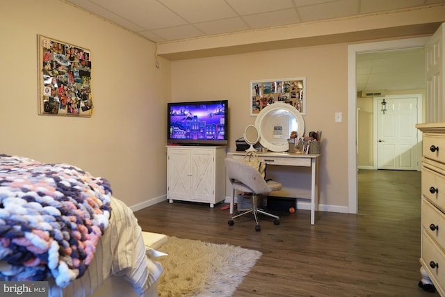 bedroom featuring a paneled ceiling and dark wood-type flooring