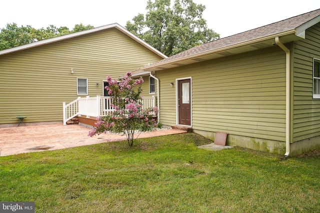 rear view of property with a patio area and a lawn