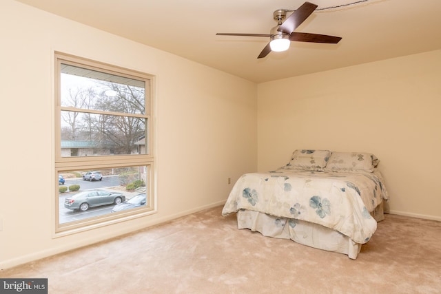 unfurnished bedroom with a ceiling fan, baseboards, and carpet flooring