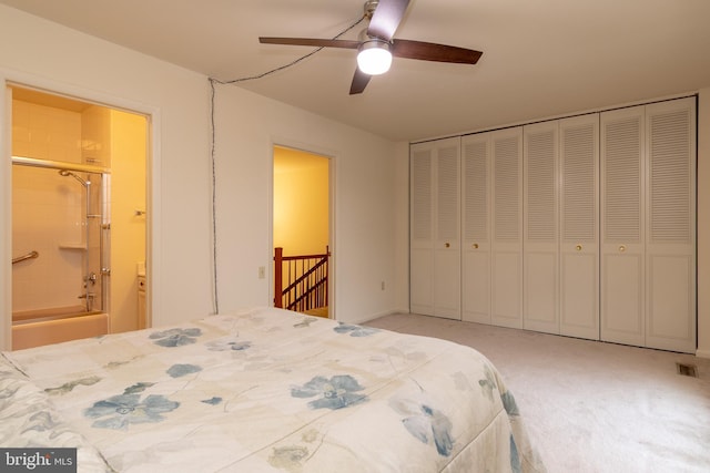 bedroom with carpet, a closet, visible vents, ensuite bathroom, and ceiling fan