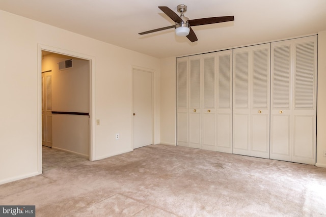 unfurnished bedroom featuring carpet floors, ceiling fan, and visible vents