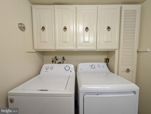 laundry room with washing machine and dryer and cabinet space