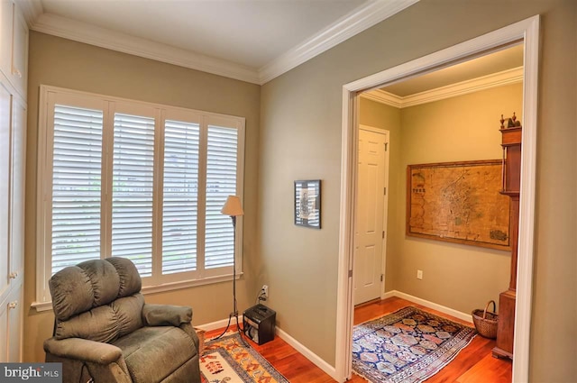 living area featuring wood-type flooring and ornamental molding