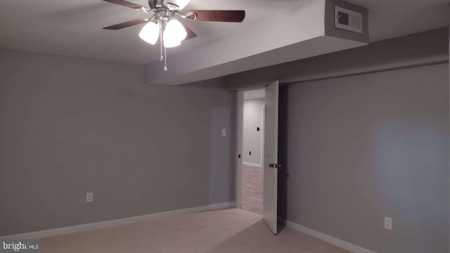 basement featuring carpet and ceiling fan