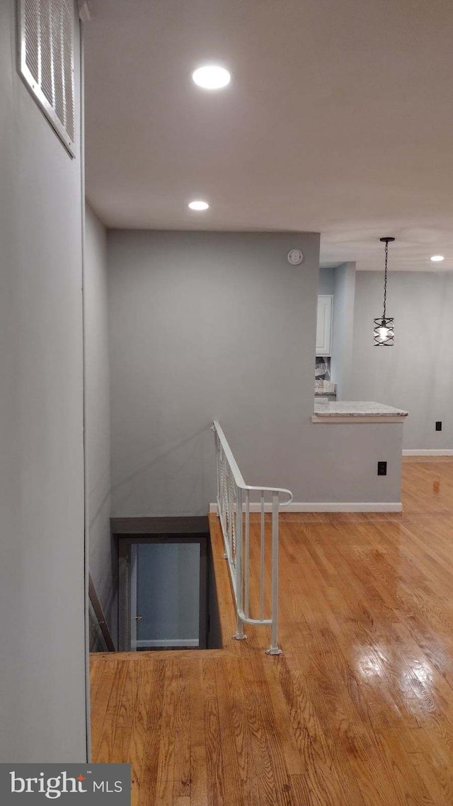 staircase with hardwood / wood-style flooring