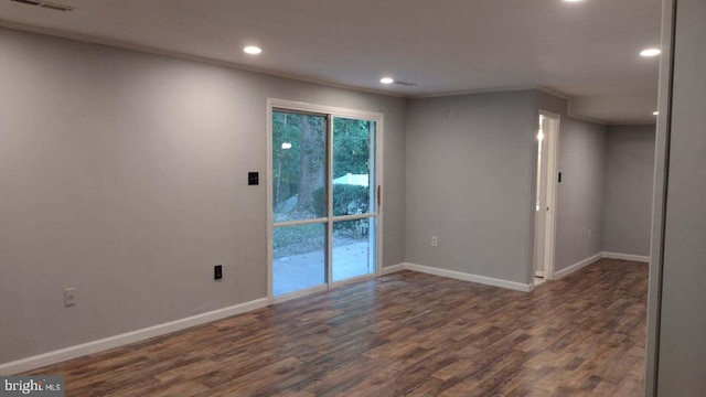 unfurnished room with dark hardwood / wood-style flooring