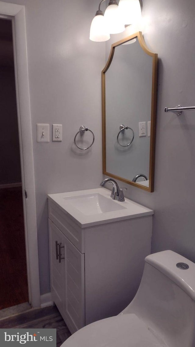 bathroom featuring vanity and toilet