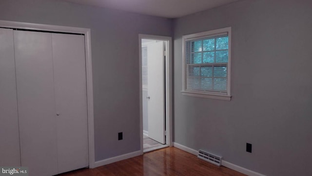 unfurnished bedroom with hardwood / wood-style flooring