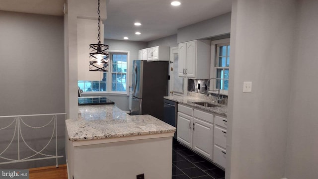 kitchen with stainless steel fridge, sink, pendant lighting, dishwasher, and white cabinetry