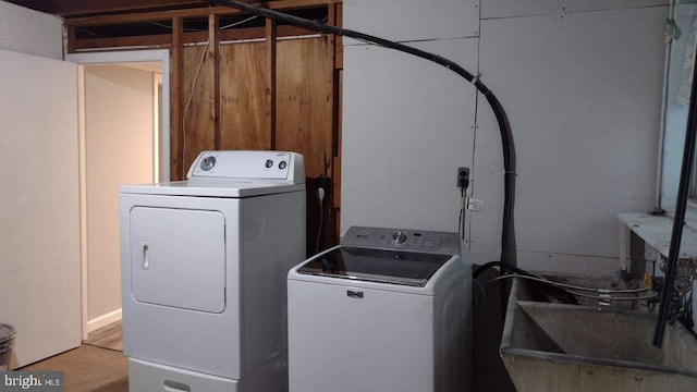 washroom featuring washing machine and dryer and sink