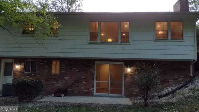 rear view of property featuring central AC unit