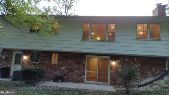 back of house with central air condition unit