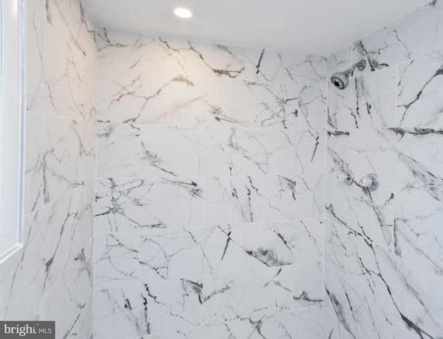 interior details with a tile shower