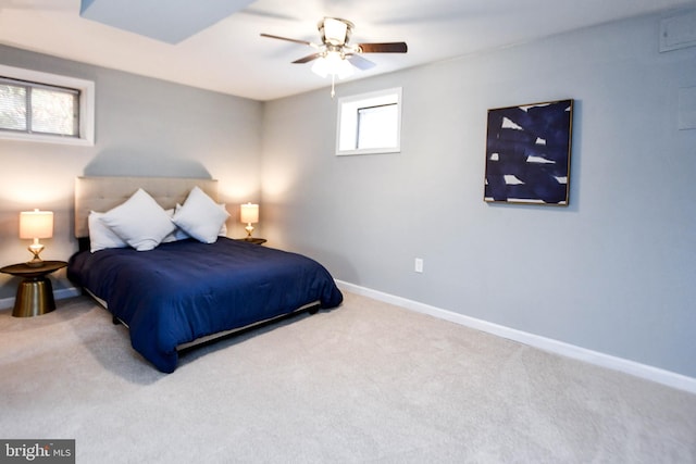 carpeted bedroom with ceiling fan and multiple windows