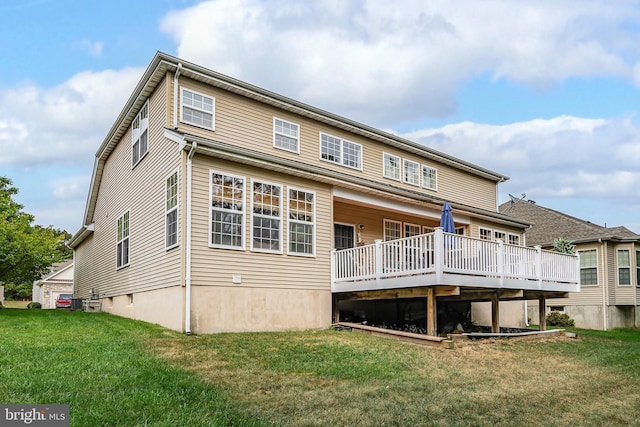 rear view of property featuring a lawn and a wooden deck