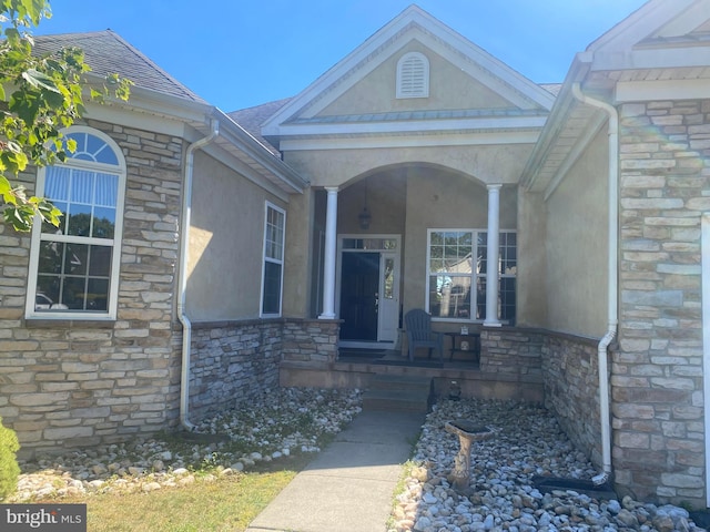 view of exterior entry featuring a porch