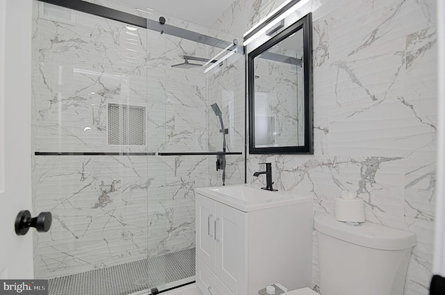 bathroom with vanity, toilet, and an enclosed shower