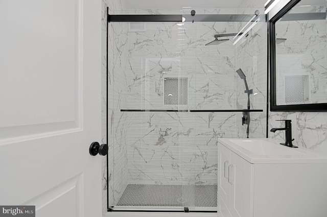 bathroom with vanity and a shower with shower door