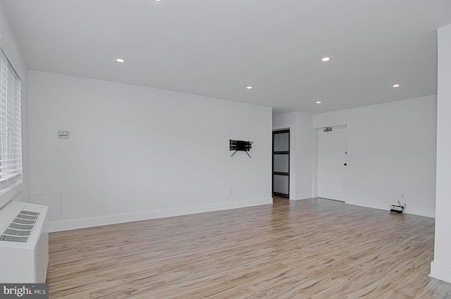 spare room with light hardwood / wood-style floors