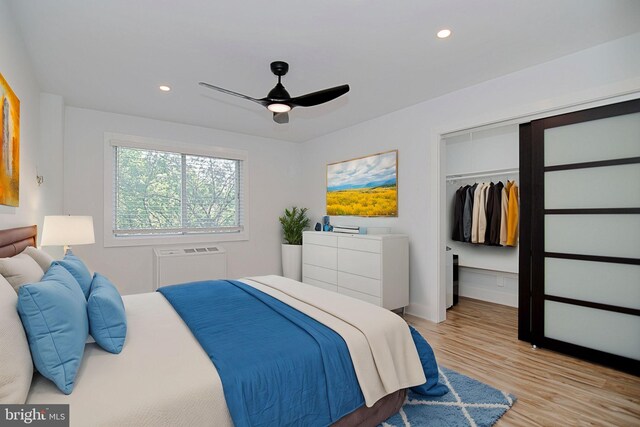 bedroom featuring ceiling fan, a closet, and light wood-type flooring