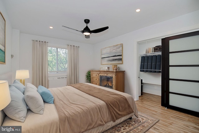 bedroom with light hardwood / wood-style floors and ceiling fan