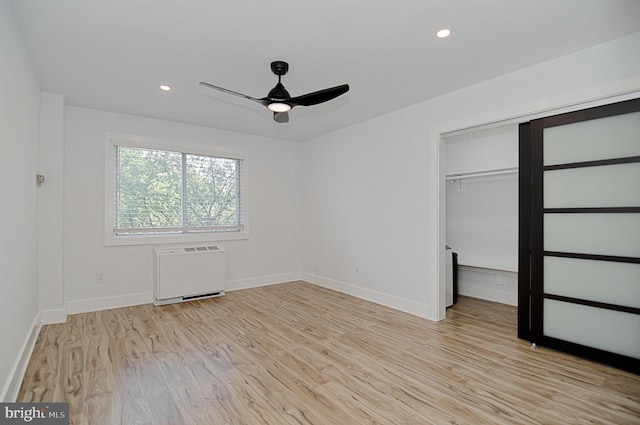 empty room featuring light wood-type flooring and ceiling fan