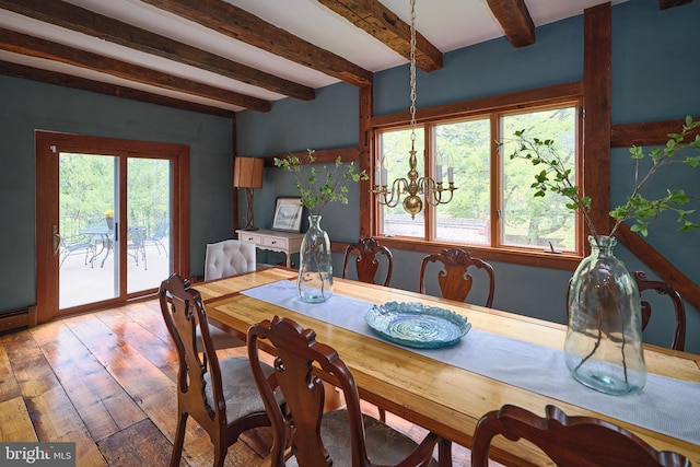 dining area with a notable chandelier, light wood-type flooring, plenty of natural light, and beam ceiling