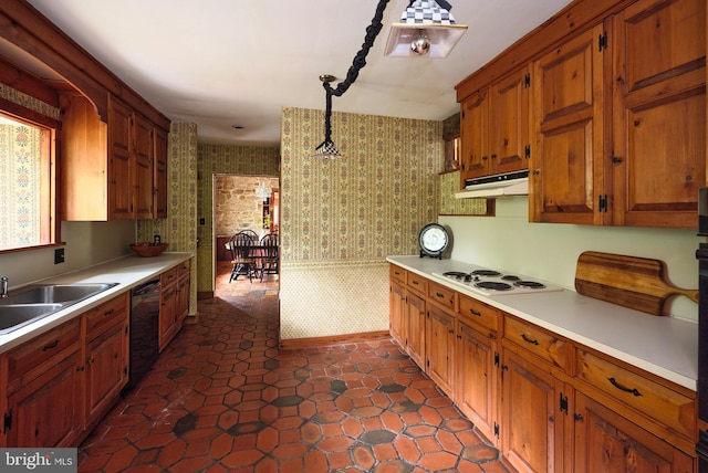 kitchen featuring hanging light fixtures, white stovetop, dishwasher, dark tile patterned floors, and sink