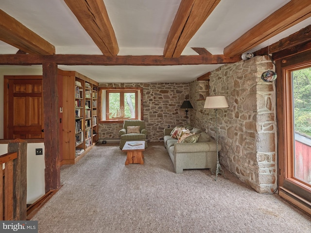 unfurnished living room featuring carpet flooring and beam ceiling