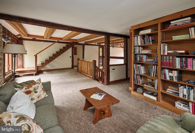 sitting room featuring beam ceiling, light colored carpet, and a healthy amount of sunlight