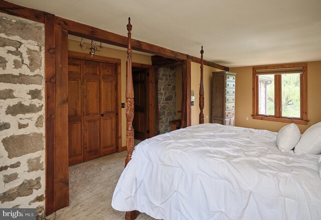 bedroom with light carpet and a closet