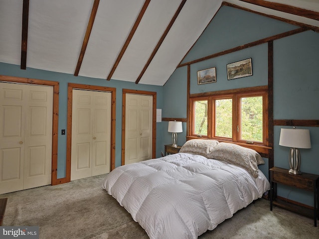 carpeted bedroom with high vaulted ceiling, multiple closets, and beamed ceiling