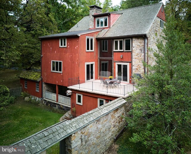 back of house with a wooden deck